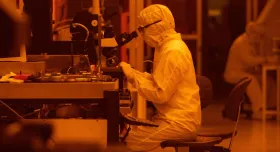 Frances Camille Wu, a graduate research assistant in the Microelectronics Research Center, uses a microscope to study electronic devices in a clean room at the Pickle Research Campus in Austin, Texas.