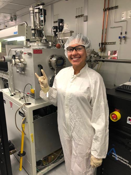 Wendilyn Ilund, a previous RET at UT, stands in her summer laboratory. She is wearing personal protective gear including safety goggles and gloves.