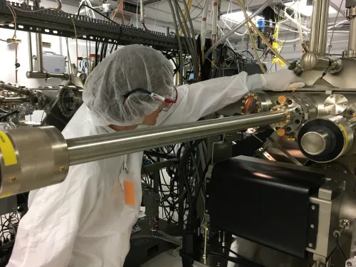 Andrew MacArthur, a past REU student, conducts research in a clean room.