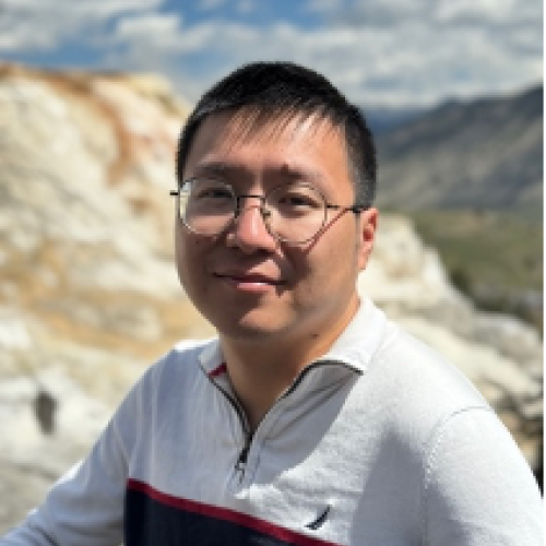 Headshot of Fan Zhang standing in front of a canyon.
