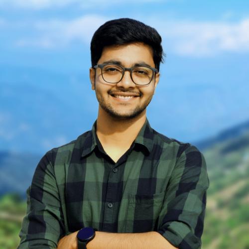 Headshot of Arjit wearing a green and blue flannel