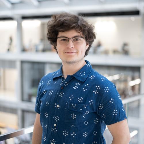 Headshot of David in a blue collared shirt