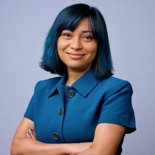 Headshot of Moumita in a blue collared shirt