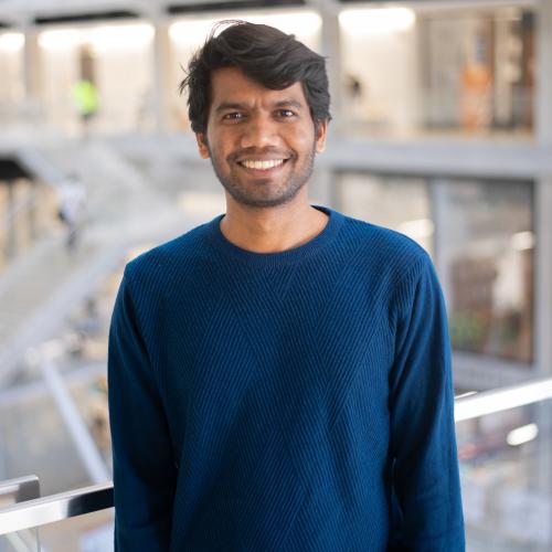Headshot of Aniket in a blue sweater