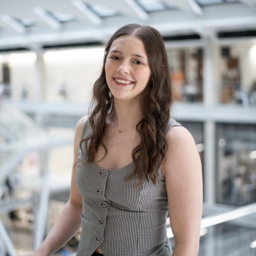 Headshot of Jenna in a grey vest